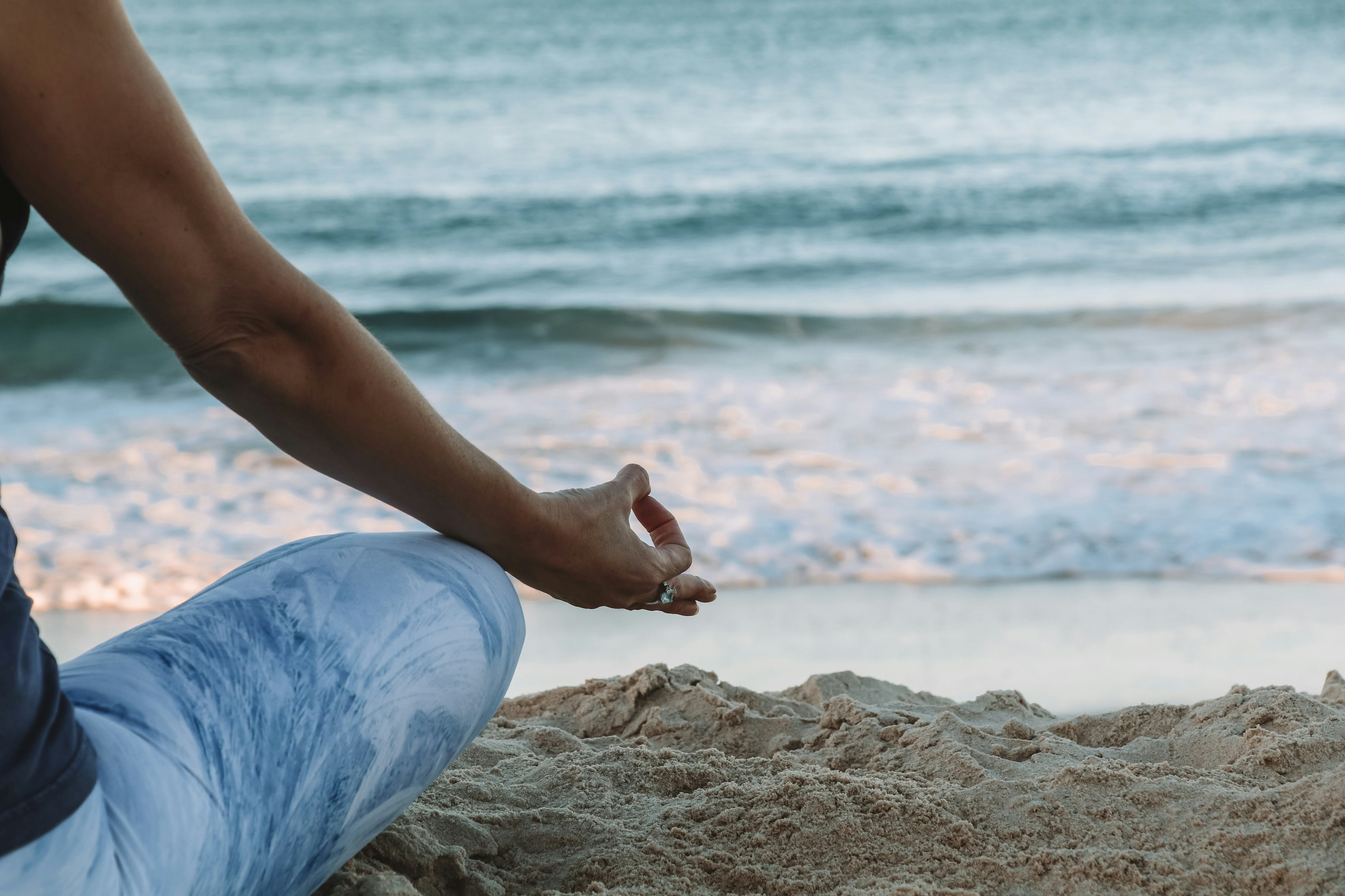 Practising morning meditation by the beach